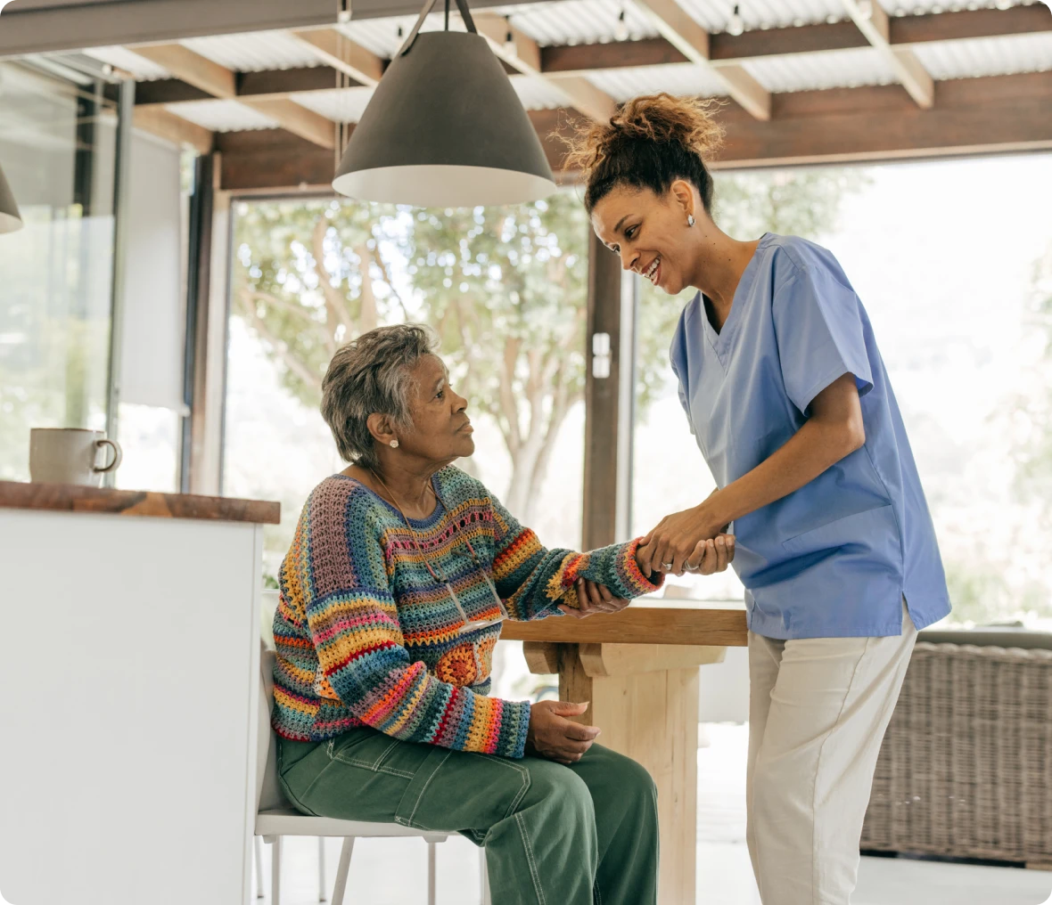 Nurse supporting senior woman with a smile