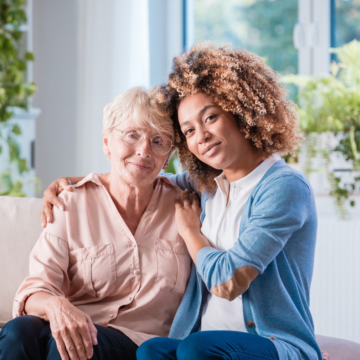 Two women sitting together on couch
