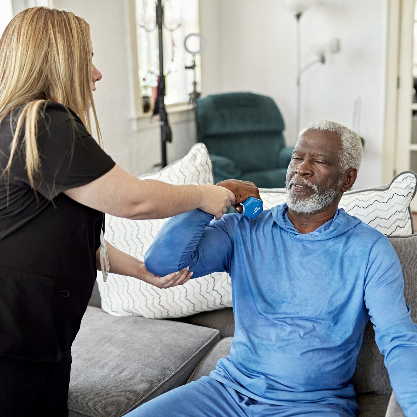 Woman taking blood pressure on sofa.