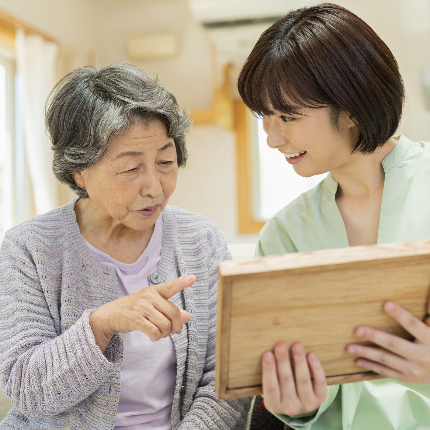 Senior discussing with a caregiver at home