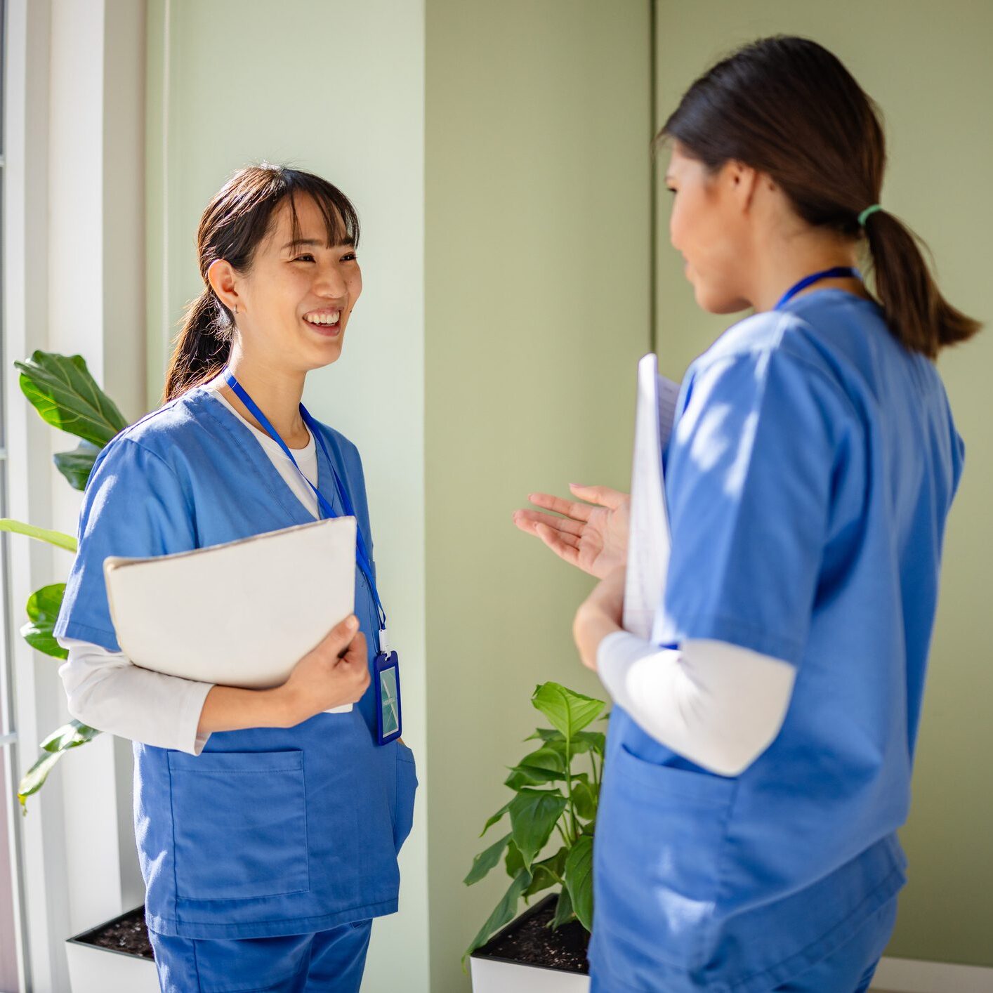 Nurses talking in hospital corridor