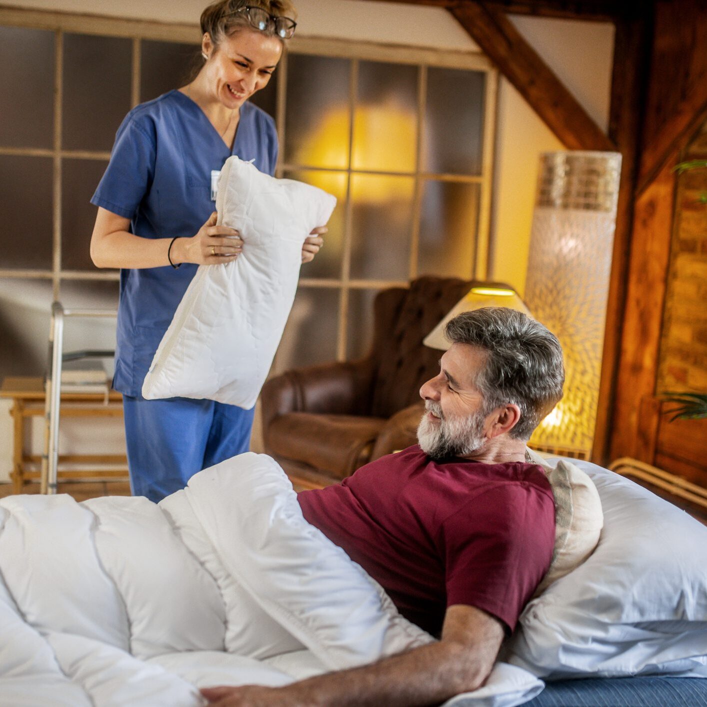 Nurse assisting patient with pillow