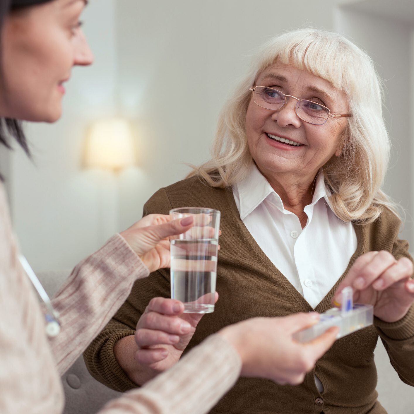 Elderly woman receiving medication assistance